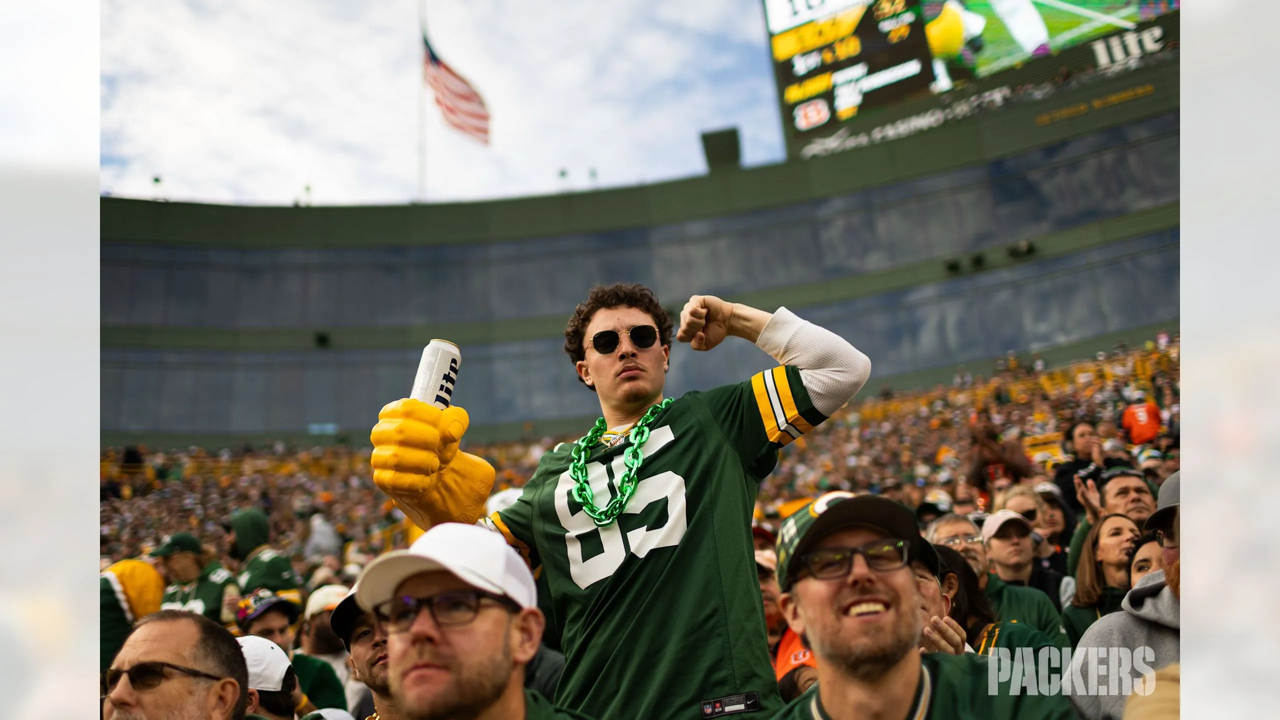 Packer Fan in jersey cheering at Lambeau Field