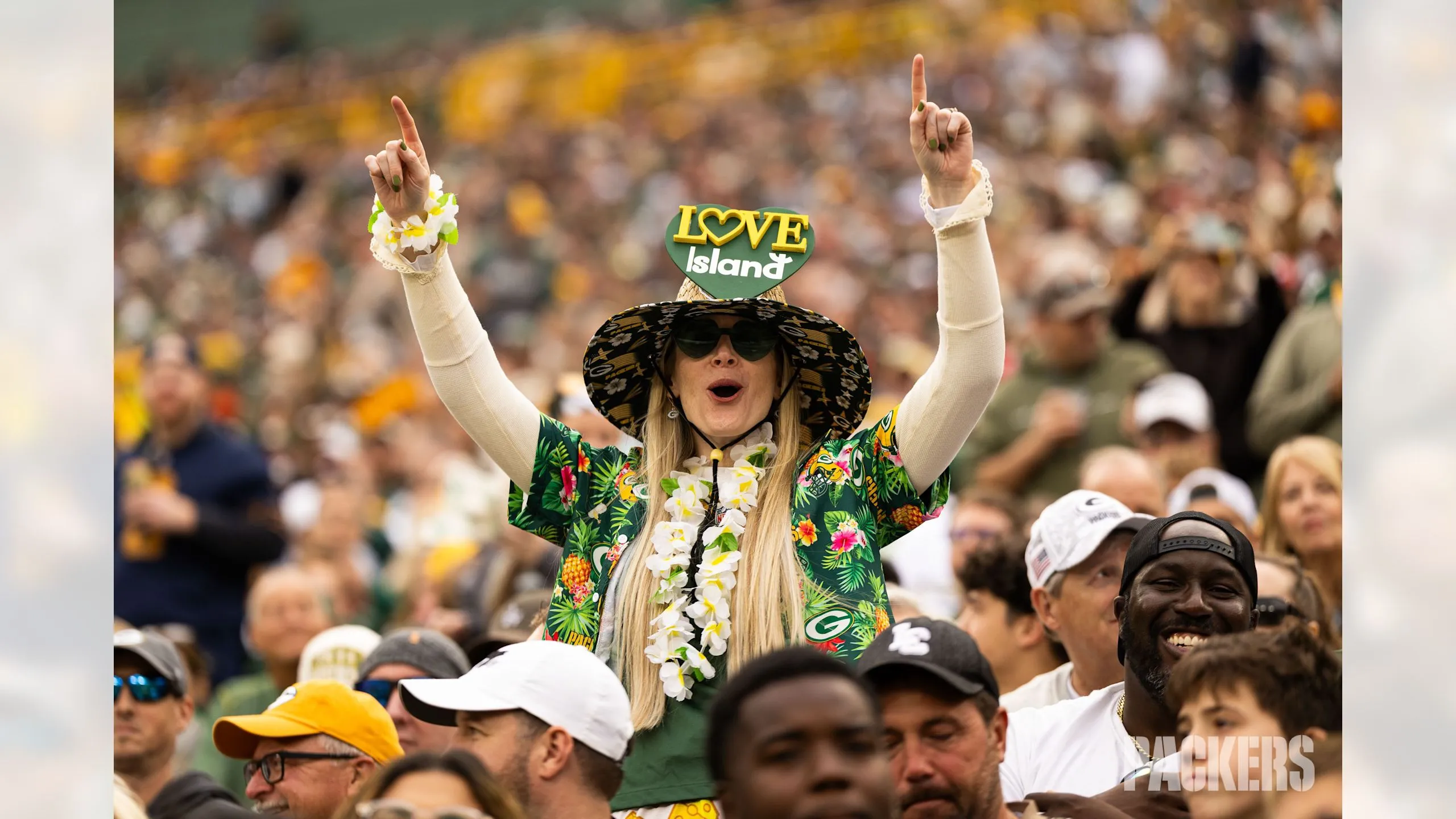 Green Bay Packers fans in jerseys cheering at Lambeau Field tailgate